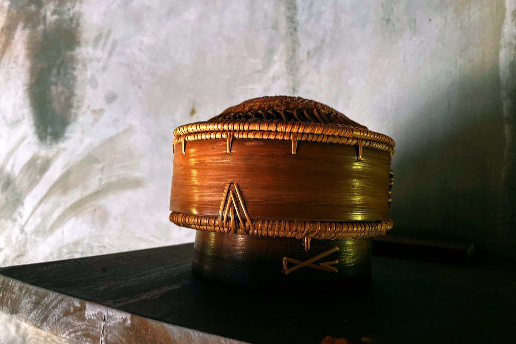 A handwoven bamboo basket in warm, soft light