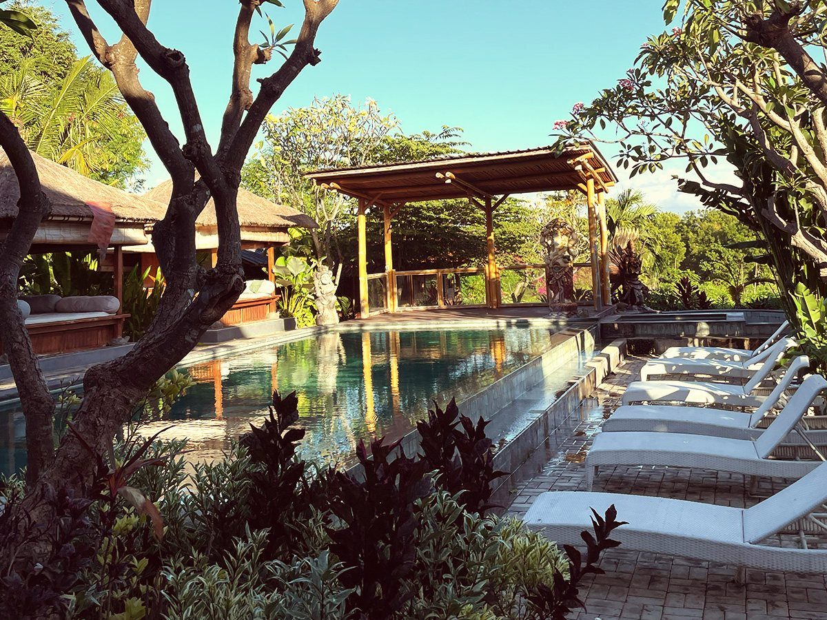 Poolside loungers and tropical planting at a place curated by C.U.D.